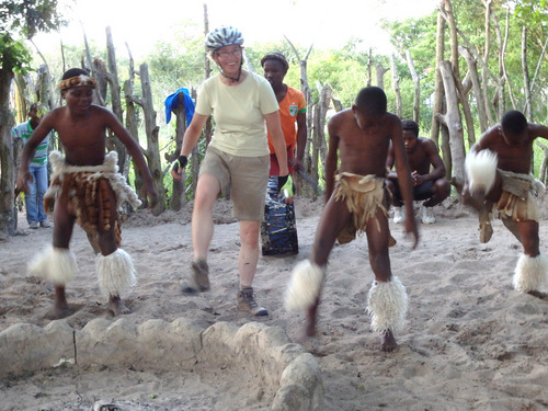 Terry is performing Zulu dance steps in a Zulu Village.